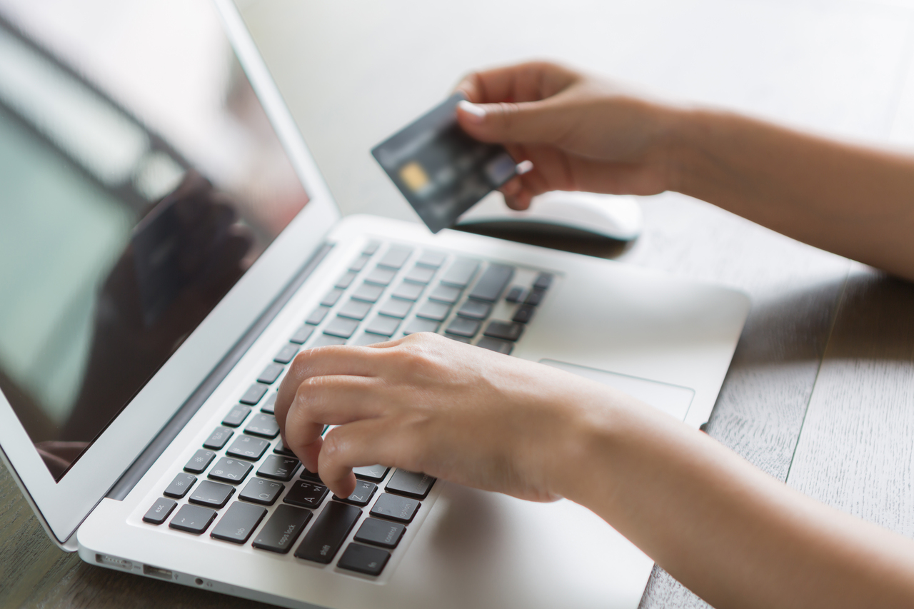 person-writing-laptop-with-credit-card.jpg
