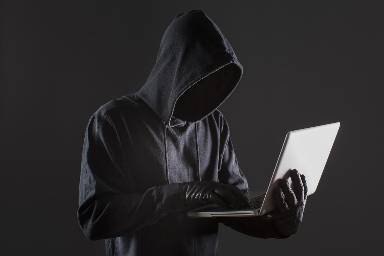 side-view-male-hacker-with-gloves-laptop_2_1.jpg